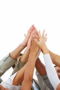 Education team - hands raised showing sign of success